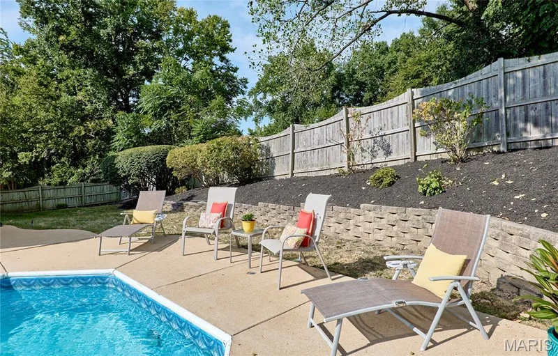 Outdoor concrete patio with an in-ground pool featuring a tiled edge — 1843 Shadywood Court, Chesterfield, MO 63017