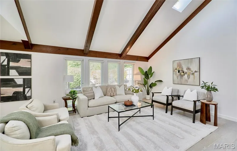 Vaulted ceiling with exposed wood beams, skylight, and large windows with blinds — 1843 Shadywood Court, Chesterfield, MO 63017