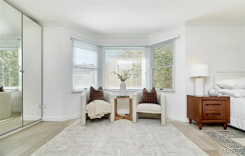 Bay window with white blinds, wood-finish flooring, and white walls — 1843 Shadywood Court, Chesterfield, MO 63017