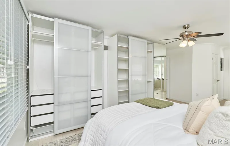 Built-in storage solutions with frosted panels, white cabinetry, and integrated drawers — 1843 Shadywood Court, Chesterfield, MO 63017