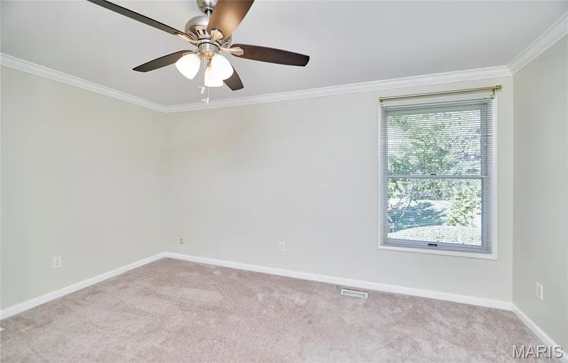 Upper level bedroom with neutral wall color, crown molding, ceiling fan with light fixture, carpeted flooring, single window — 1843 Shadywood Court, Chesterfield, MO 63017
