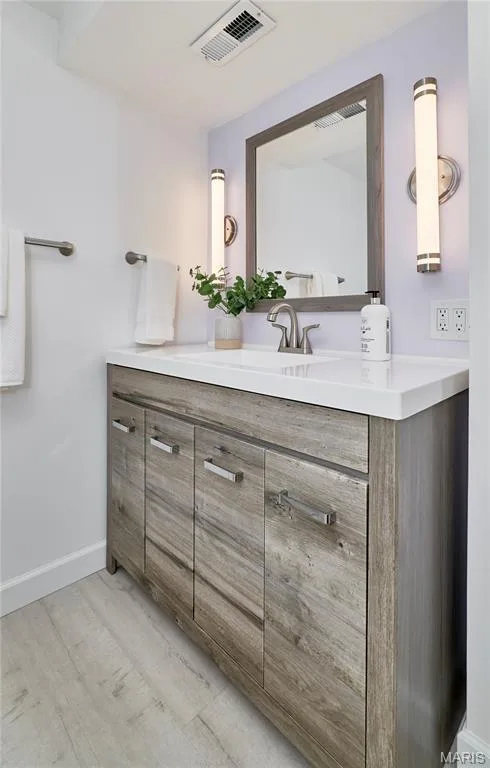 Wood-finish vanity with a white countertop and undermount sink — 1843 Shadywood Court, Chesterfield, MO 63017