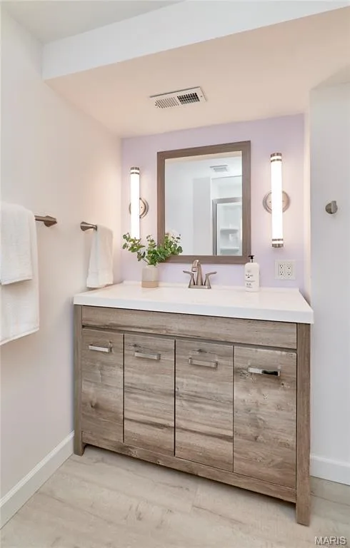 Wood-finish vanity with a white countertop and undermount sink — 1843 Shadywood Court, Chesterfield, MO 63017