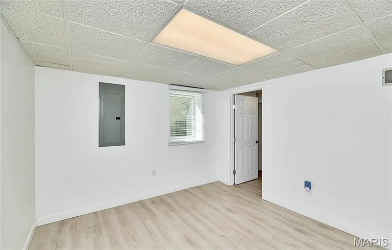 Recessed lighting, drop ceiling, wood-finish flooring, white walls, and a window with blinds — 1843 Shadywood Court, Chesterfield, MO 63017