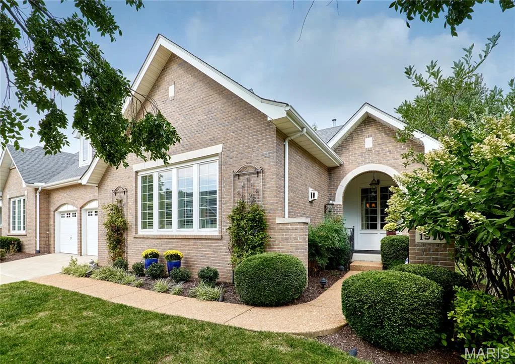 Brick exterior with white trim, arched entryway, and a two-car garage — 1970 Chesterfield Ridge Circle, Chesterfield, MO 63017