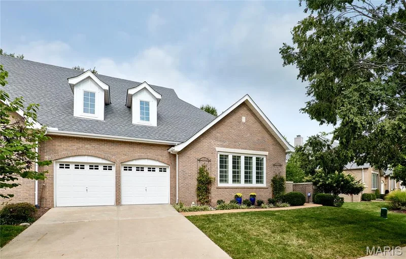 Brick exterior with white trim, featuring a two-car garage — 1970 Chesterfield Ridge Circle, Chesterfield, MO 63017
