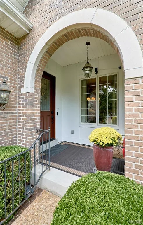Brick exterior with a stone archway, covered entry, and classic hanging lantern — 1970 Chesterfield Ridge Circle, Chesterfield, MO 63017