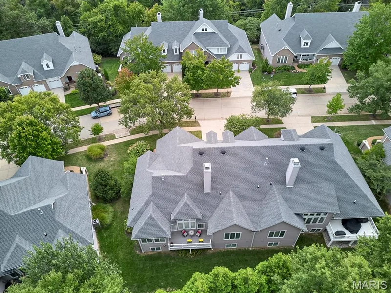 Expansive property featuring a multi-level deck, mature trees, and a spacious green lawn — 1970 Chesterfield Ridge Circle, Chesterfield, MO 63017