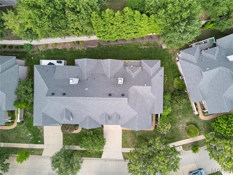 Gable roof design with gray shingles, surrounded by mature trees and manicured lawns — 1970 Chesterfield Ridge Circle, Chesterfield, MO 63017