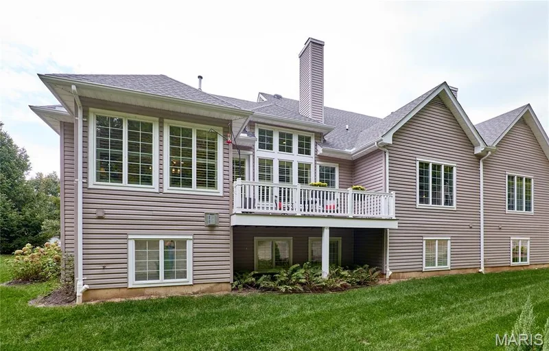 Multi-level residence featuring extensive window placements, an elevated outdoor deck, and horizontal siding — 1970 Chesterfield Ridge Circle, Chesterfield, MO 63017