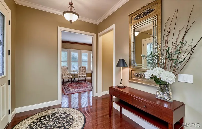 Wood-finish flooring, crown molding, and a decorative ceiling fixture — 1970 Chesterfield Ridge Circle, Chesterfield, MO 63017