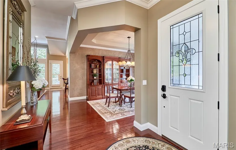 Entry with leaded glass paneled door, wood-finish flooring, and crown molding — 1970 Chesterfield Ridge Circle, Chesterfield, MO 63017