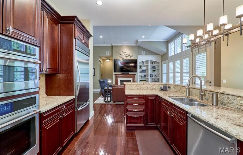Hardwood flooring, Thermador gas cooktop, electric oven and U-shaped countertop, and wood-finish cabinetry — 1970 Chesterfield Ridge Circle, Chesterfield, MO 63017