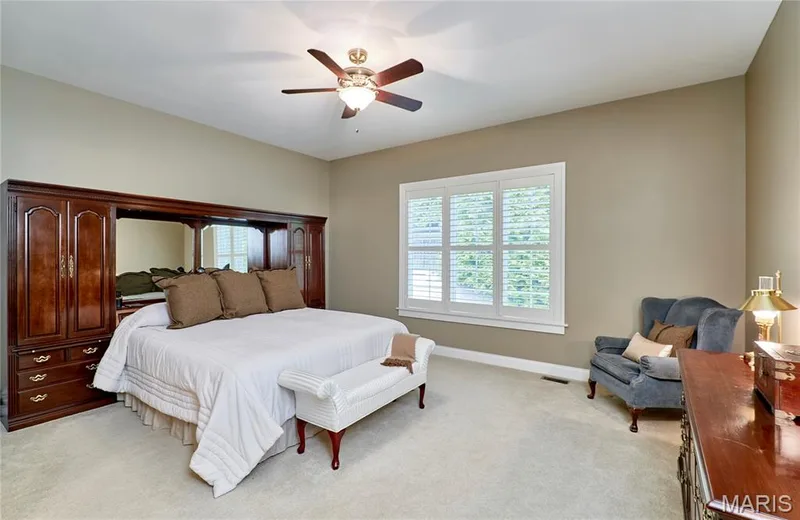 Recessed lighting, ceiling fan, neutral wall tones, white plantation shutters, and light-toned carpeting — 1970 Chesterfield Ridge Circle, Chesterfield, MO 63017