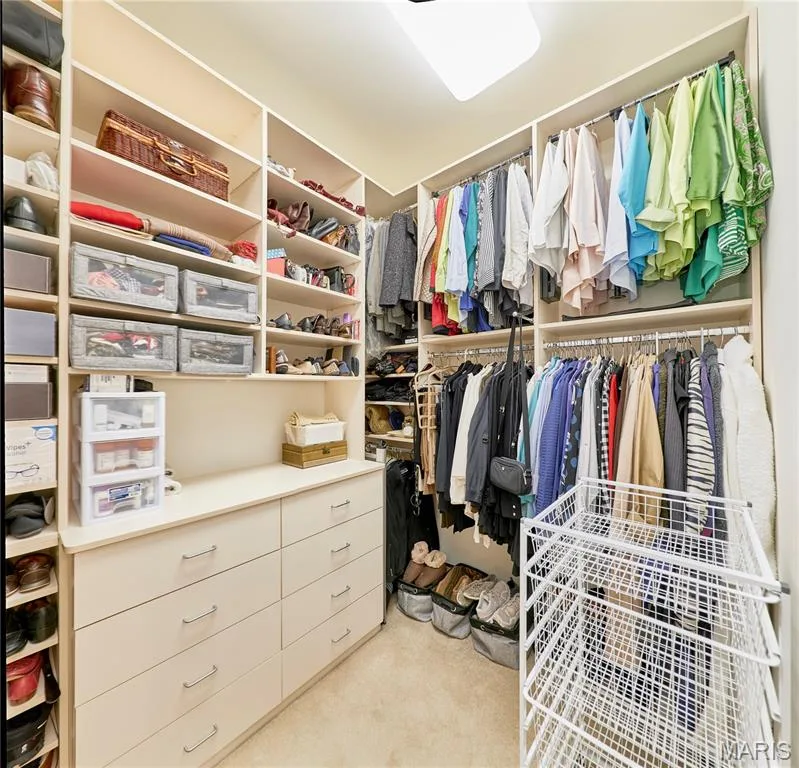 Built-in closet system featuring extensive shelving, hanging rods, and integrated drawer storage — 1970 Chesterfield Ridge Circle, Chesterfield, MO 63017