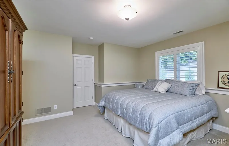 Recessed window with plantation shutters, crown molding, paneled door, flush mount ceiling light, and carpeted flooring — 1970 Chesterfield Ridge Circle, Chesterfield, MO 63017