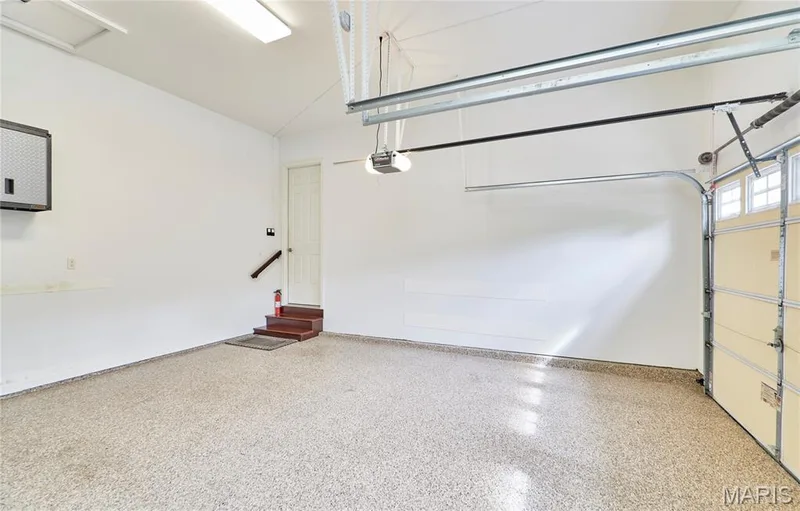 Coated flooring, built-in shelving, wood-finish stairs, and overhead lighting fixtures — 1970 Chesterfield Ridge Circle, Chesterfield, MO 63017