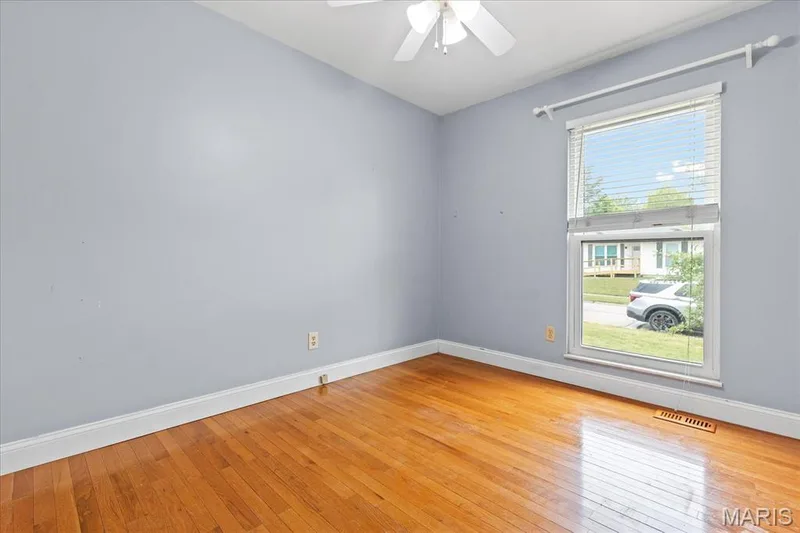 The third bedroom with ceiling fan and large window — 1353 Osage Meadows Drive, O'Fallon, MO 63366