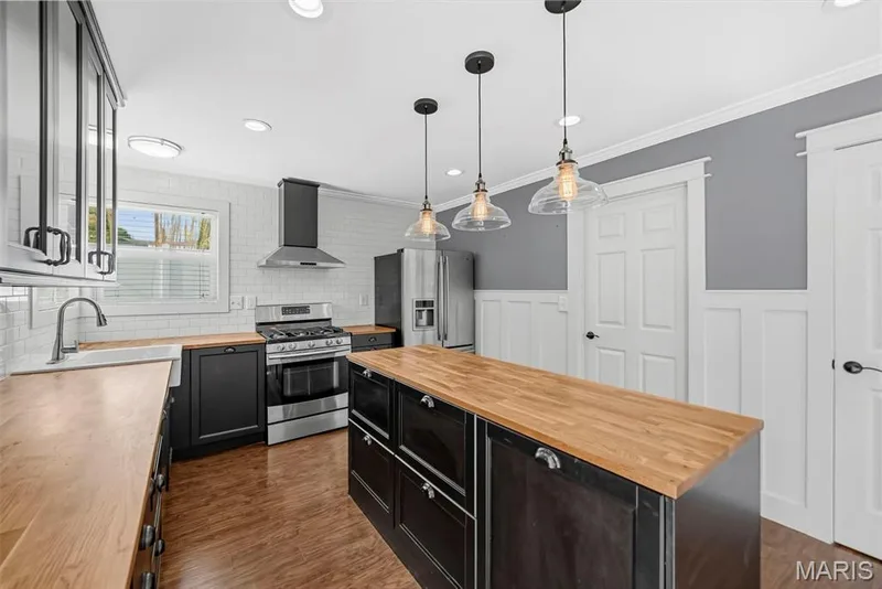 Recessed lighting throughout the kitchen, gas stove, large drawers in center island — 242 Ashford Oaks Drive, Wentzville, MO 63385