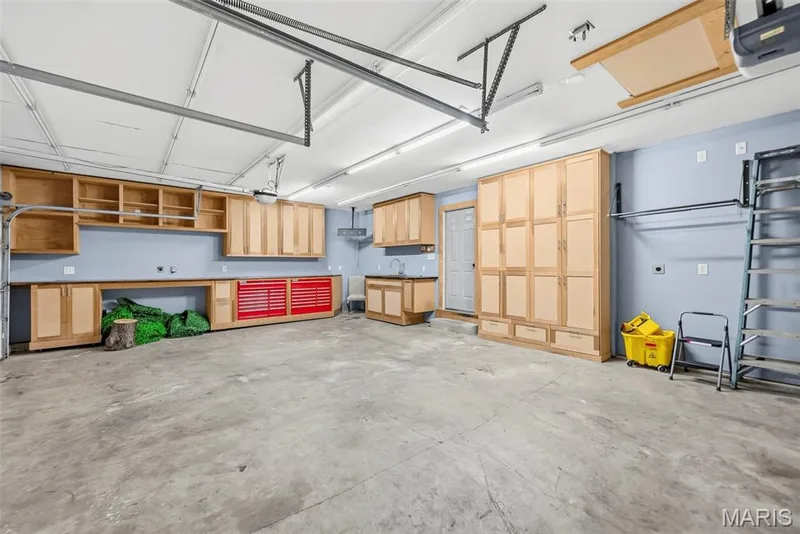 Extensive built-in cabinetry, integrated work surfaces, and a utility sink — 242 Ashford Oaks Drive, Wentzville, MO 63385