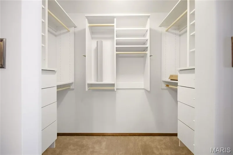 Primary bedroom walk-in closet with organizing system. — 2 Rockwood Forest Glen, Wildwood, MO 63025