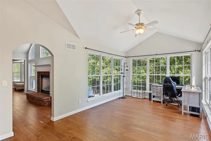 Vaulted ceiling, ceiling fan, wood-finish flooring, large windows, arched doorway — 521 Sceptre Road, Wentzville, MO 63385
