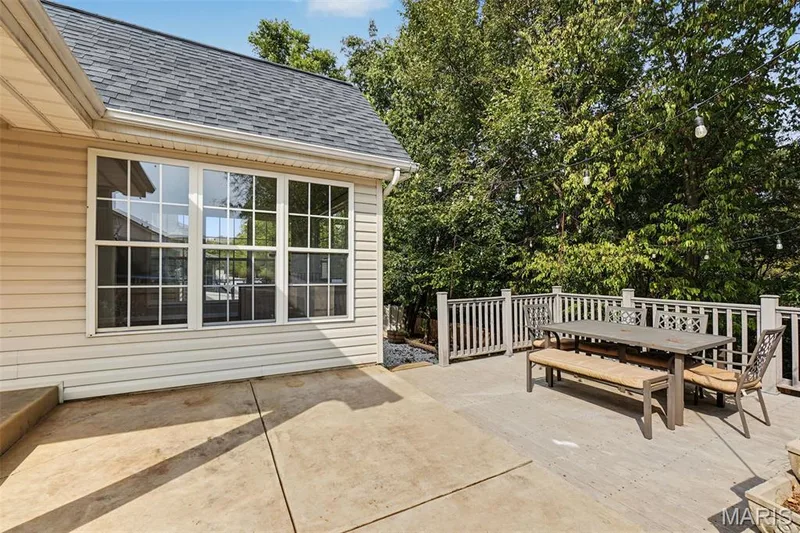 Spacious outdoor deck with a gray wood finish, bordered by a white railing — 521 Sceptre Road, Wentzville, MO 63385