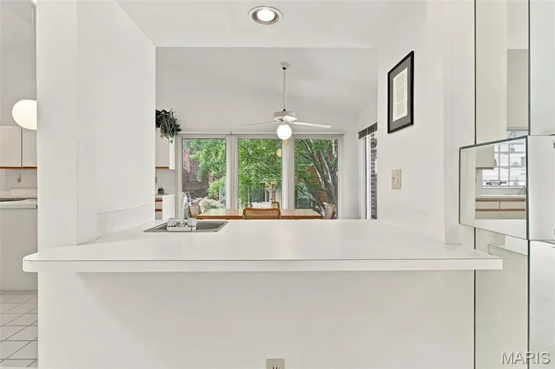 Kitchen passthrough with a stainless sink, vaulted ceiling, recessed lighting — 14033 Baywood Villages Drive, Chesterfield, MO 63017