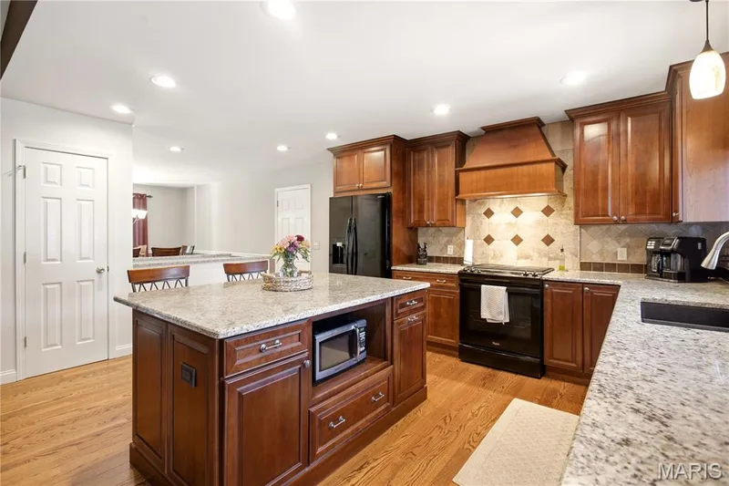 Updated kitchen with granite counter tops — 733 Cedar Glen Drive, Weldon Spring, MO 63304