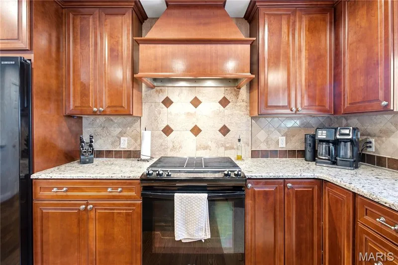Beautiful range hood and detail to the cabinets — 733 Cedar Glen Drive, Weldon Spring, MO 63304