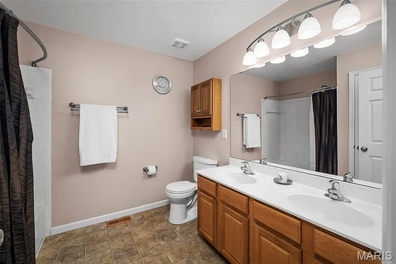 Dual sinks keep the peace in the primary bathroom. — 17 Belmonte Court, Lake St. Louis, MO 63368