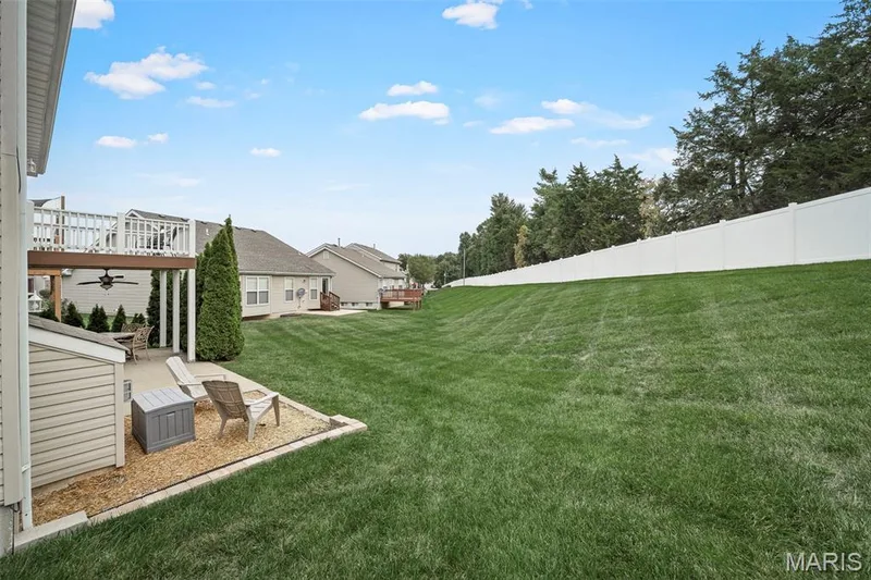 Backing to lush green grass and evergreen on the tree line. — 17 Belmonte Court, Lake St. Louis, MO 63368