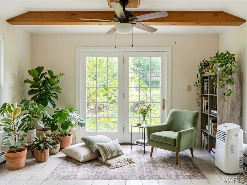 Sunroom featuring white-tiled flooring, exposed wood ceiling beam, ceiling fan, and glass-paneled double doors — 411 Adams Street, St Charles, MO 63301