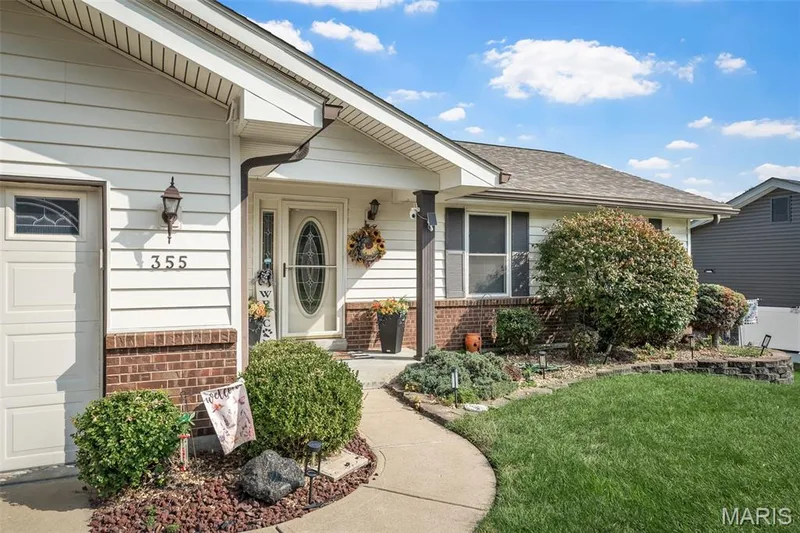 Single-story residence featuring light-toned siding and a brick base — 355 Birmingham Drive, O'Fallon, MO 63366