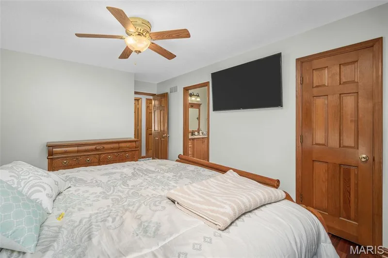 Ceiling fan with integrated lighting, wood-finish interior doors, recessed wood trim, wall-mounted display, wood-finish flooring — 355 Birmingham Drive, O'Fallon, MO 63366