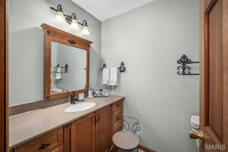 Wood-finish vanity with an integrated sink and an extended countertop — 355 Birmingham Drive, O'Fallon, MO 63366