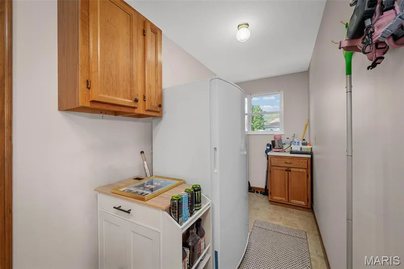 Recessed window, wood-finish flooring, overhead ceiling light fixture, wall-mounted wood cabinetry, built-in lower wood cabinetry with countertop — 355 Birmingham Drive, O'Fallon, MO 63366