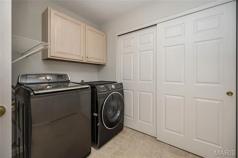 Main floor laundry with plenty of storage including a large coat closet — 117 Black Lantern Trail, St Peters, MO 63376