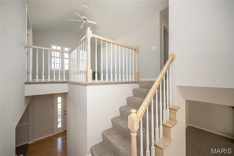 Dual staircases to the upper level (one from the breakfast room and one from the front of the home) — 117 Black Lantern Trail, St Peters, MO 63376
