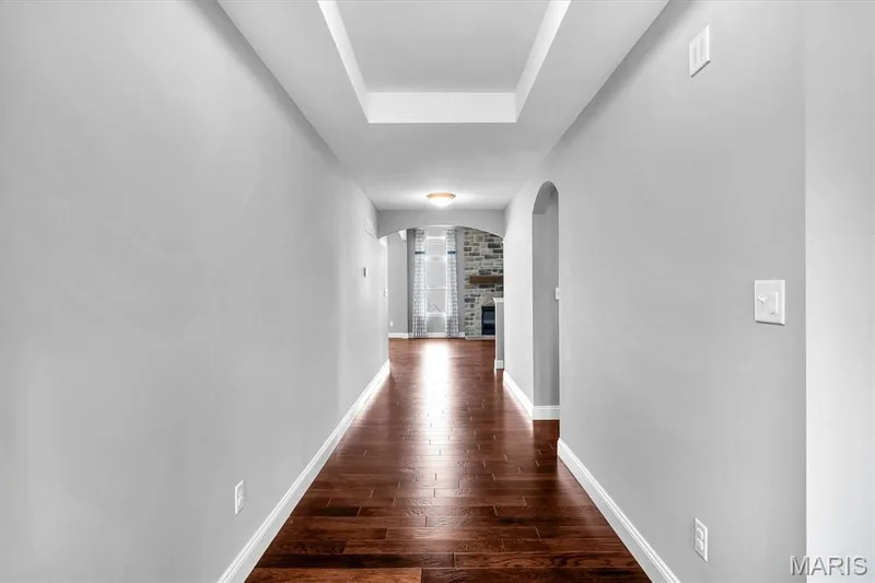 Tray ceiling with recessed lighting above wood-finish flooring — 332 Mystic Brook Drive, O'Fallon, MO 63366