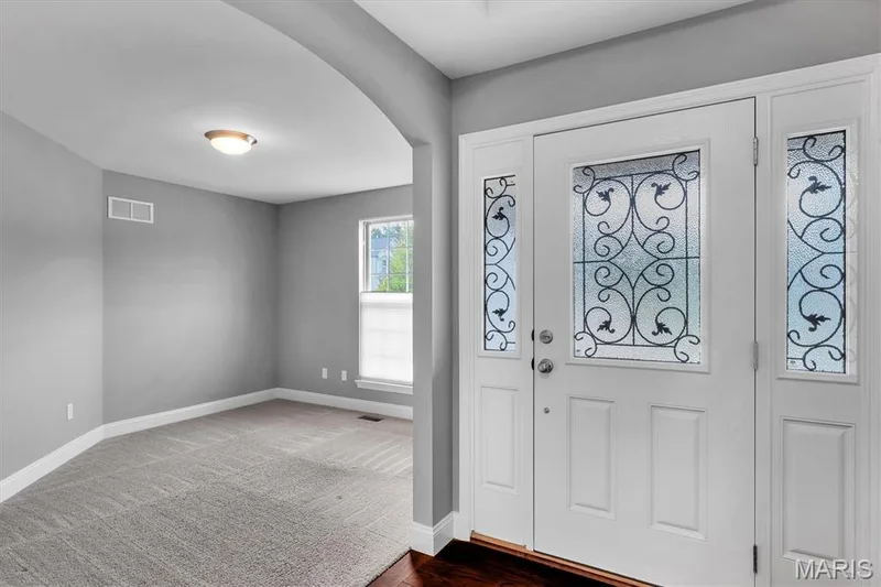 White front door with decorative glass inserts and coordinating sidelights — 332 Mystic Brook Drive, O'Fallon, MO 63366