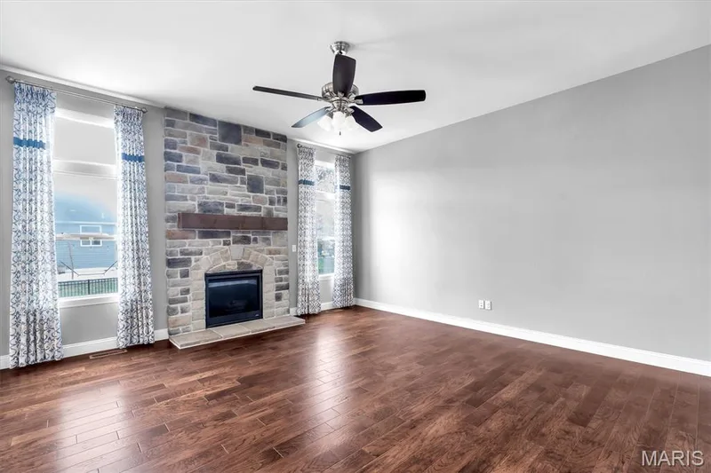 Stone-faced fireplace with a wood mantel — 332 Mystic Brook Drive, O'Fallon, MO 63366