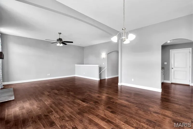 Expansive room featuring wood-finish flooring, vaulted ceiling, and recessed lighting — 332 Mystic Brook Drive, O'Fallon, MO 63366