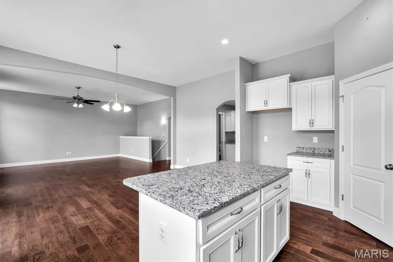 Kitchen island with stone countertop — 332 Mystic Brook Drive, O'Fallon, MO 63366