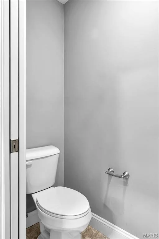 White toilet with a round bowl, brushed nickel towel bar, and light gray wall paint — 332 Mystic Brook Drive, O'Fallon, MO 63366