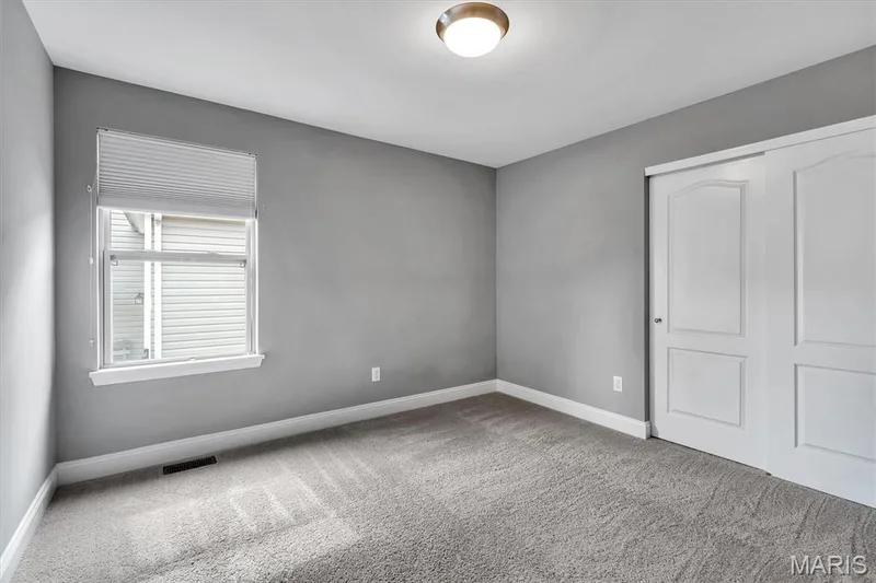 Neutral gray wall paint, white trim, recessed lighting, and carpet flooring — 332 Mystic Brook Drive, O'Fallon, MO 63366