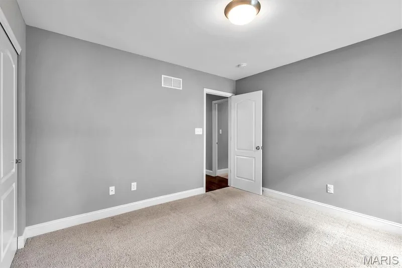 Neutral gray wall paint, white trim, recessed lighting, and soft carpet flooring — 332 Mystic Brook Drive, O'Fallon, MO 63366