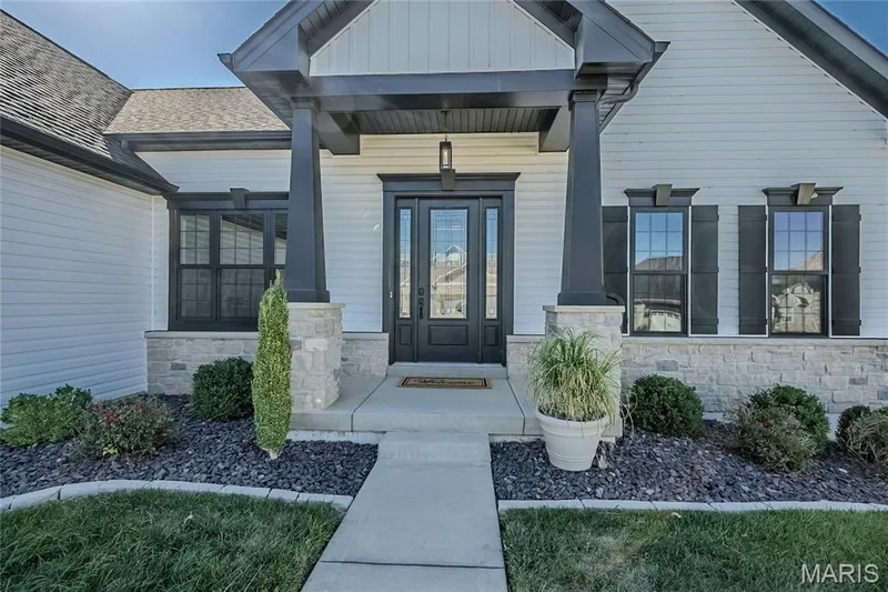 This custom built home is still fresh, just completed in 2020.  The interior has an added impact on the elevation.  11 Foot Ceilings allow for the dramatic 8 foot tall entry door.  The classic crosshead and keystone window detail.  Better yet, the black windows complete the look, that is so in demand today. — 121 Eagle Estates Drive, Lake St. Louis, MO 63367