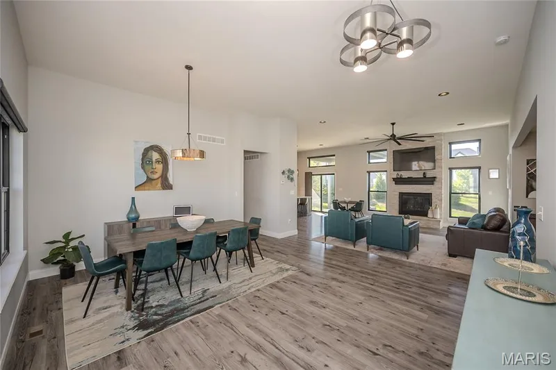 One of two dining spaces allows the party to flow for small gatherings or hosting a crowd. LVP flooring flows through the public spaces of the home. You also get a hint of the dramatic lighting that has been selected throughout the interior and exterior of the home. — 121 Eagle Estates Drive, Lake St. Louis, MO 63367