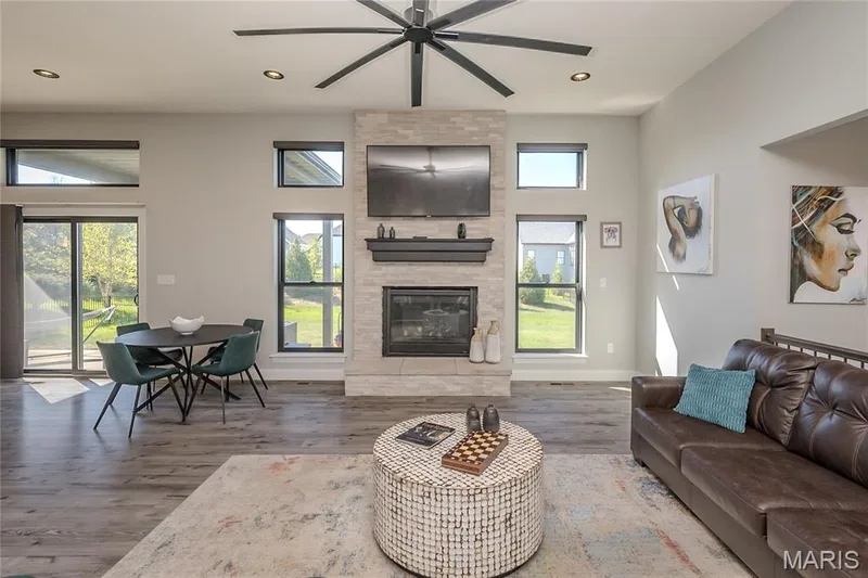 The gas fireplace completes the entertainment wall and the stone from the exterior is continued on the fireplace. There are endless possibilities for furniture placement among the three zones of this open concept. — 121 Eagle Estates Drive, Lake St. Louis, MO 63367